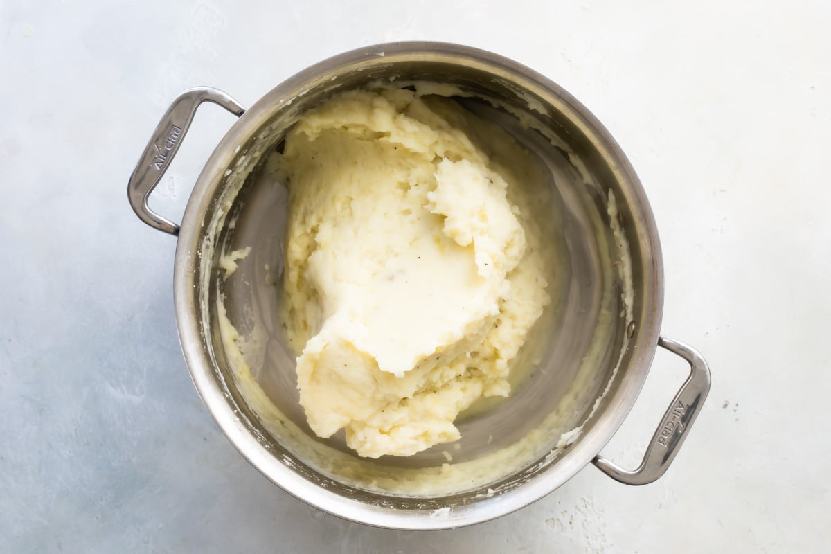 A silver pot of mashed potatoes.