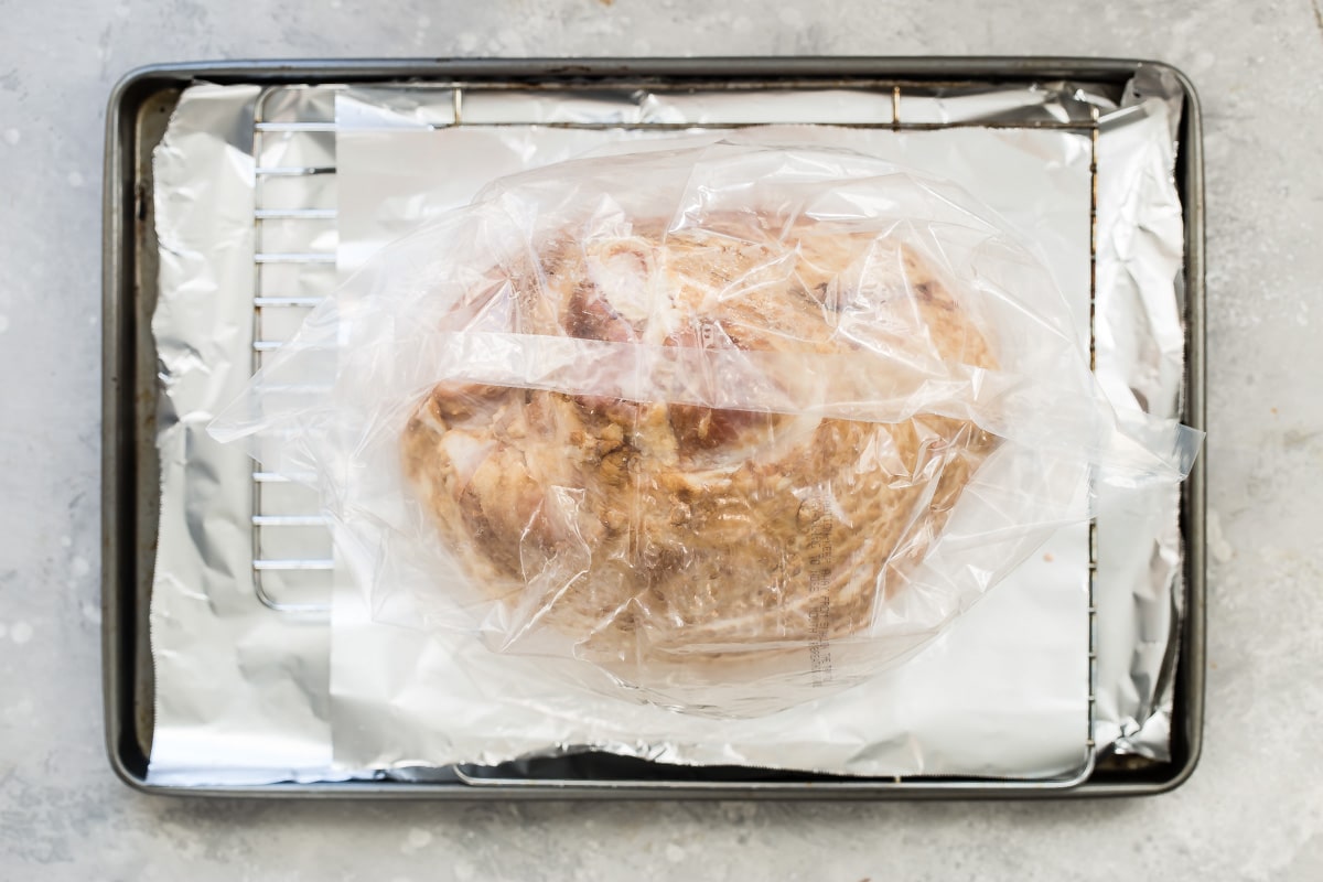 A smoked ham in an oven bag.