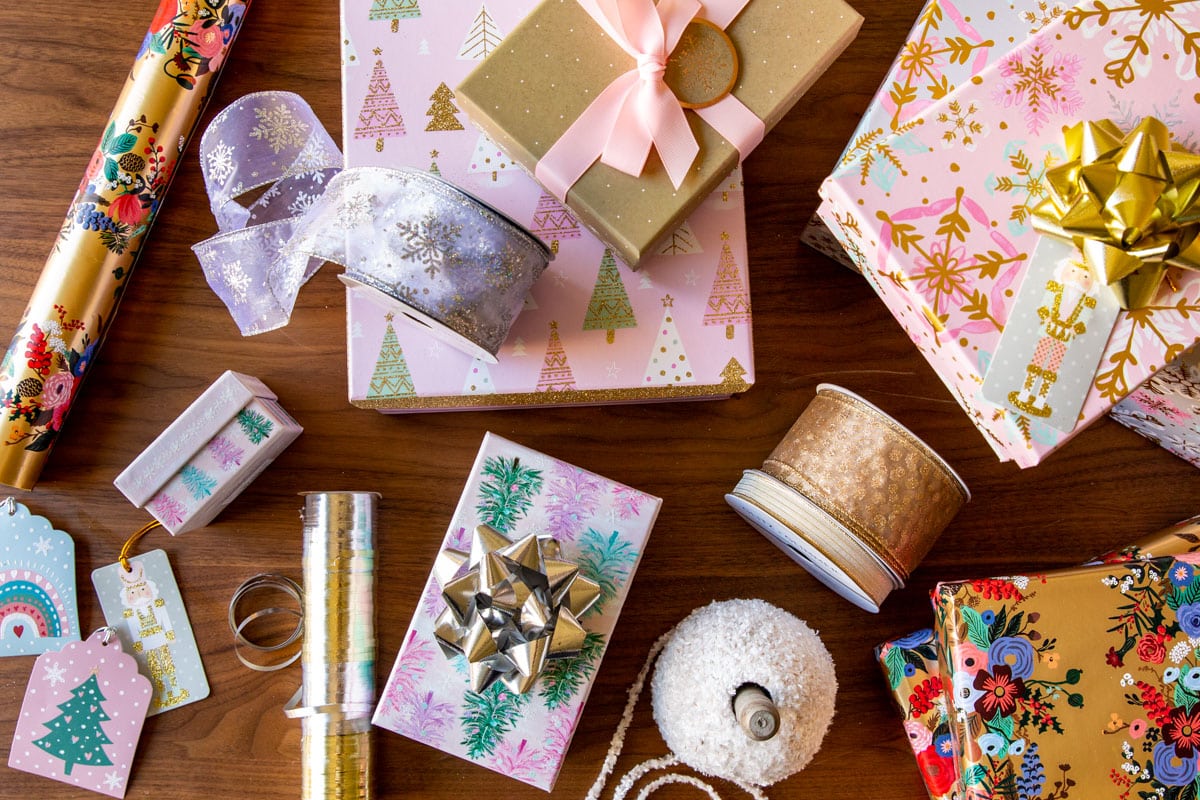 Various gift boxes, wrapping paper, ribbons, and bows for wrapping presents.