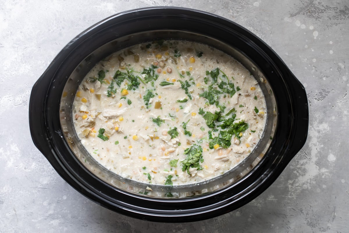 A crockpot filled with white chicken chili.