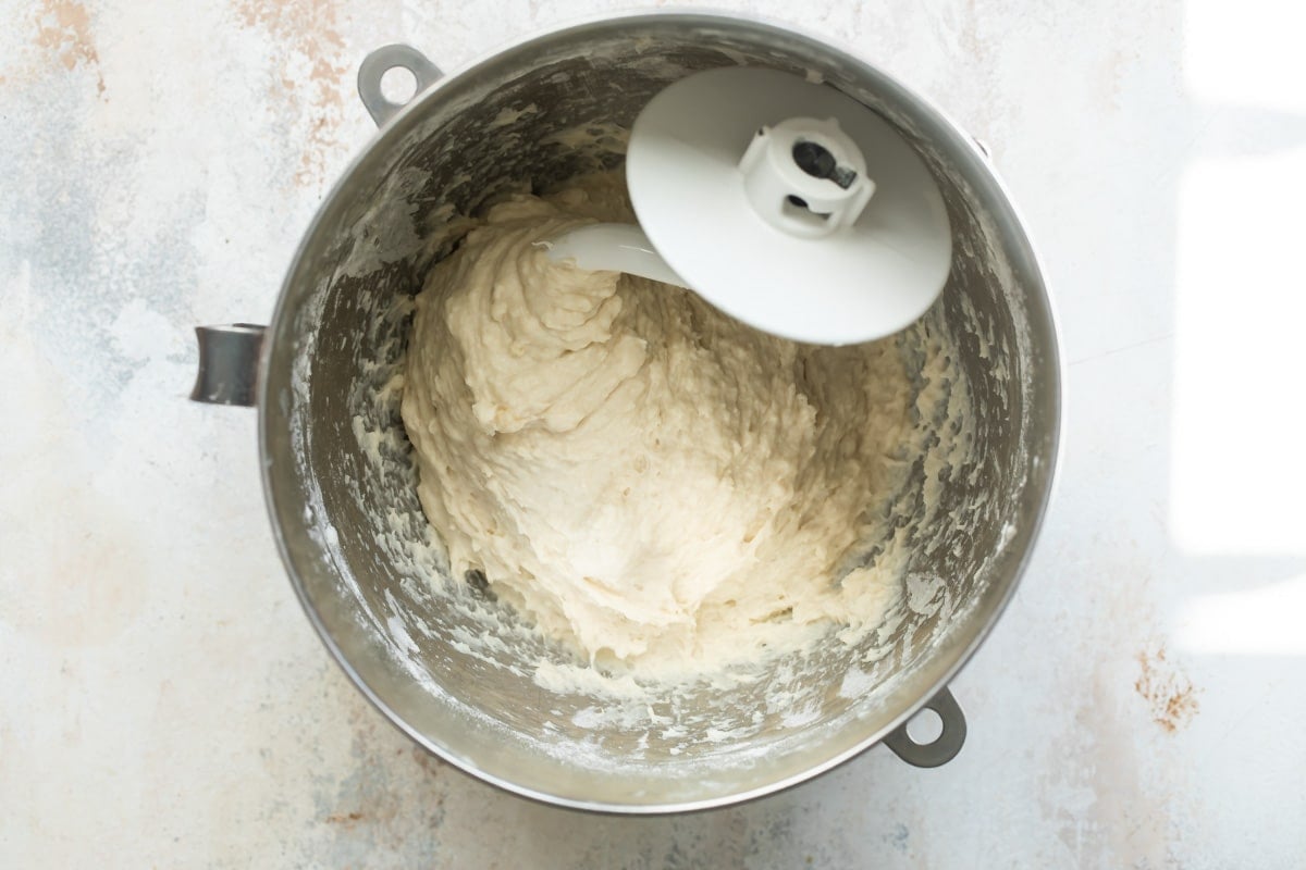 A mixing bowl of dough for dinner rolls.