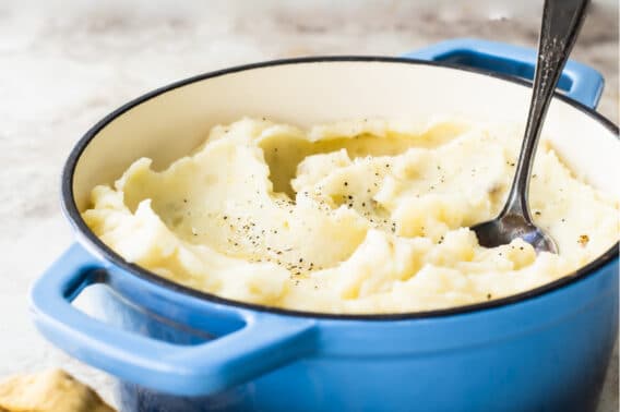 The Best Mashed Potatoes in a blue Dutch oven.