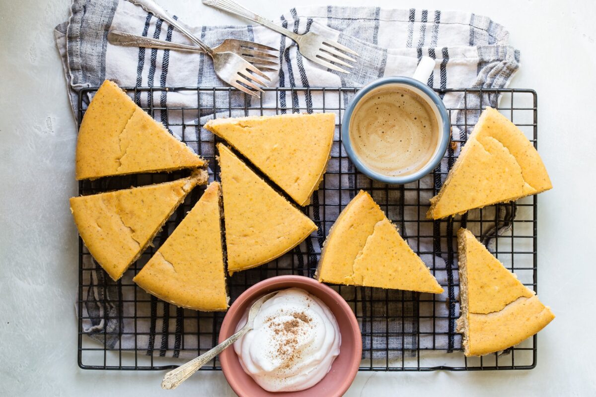 Slices of pumpkin cheesecake on a cooling rack.