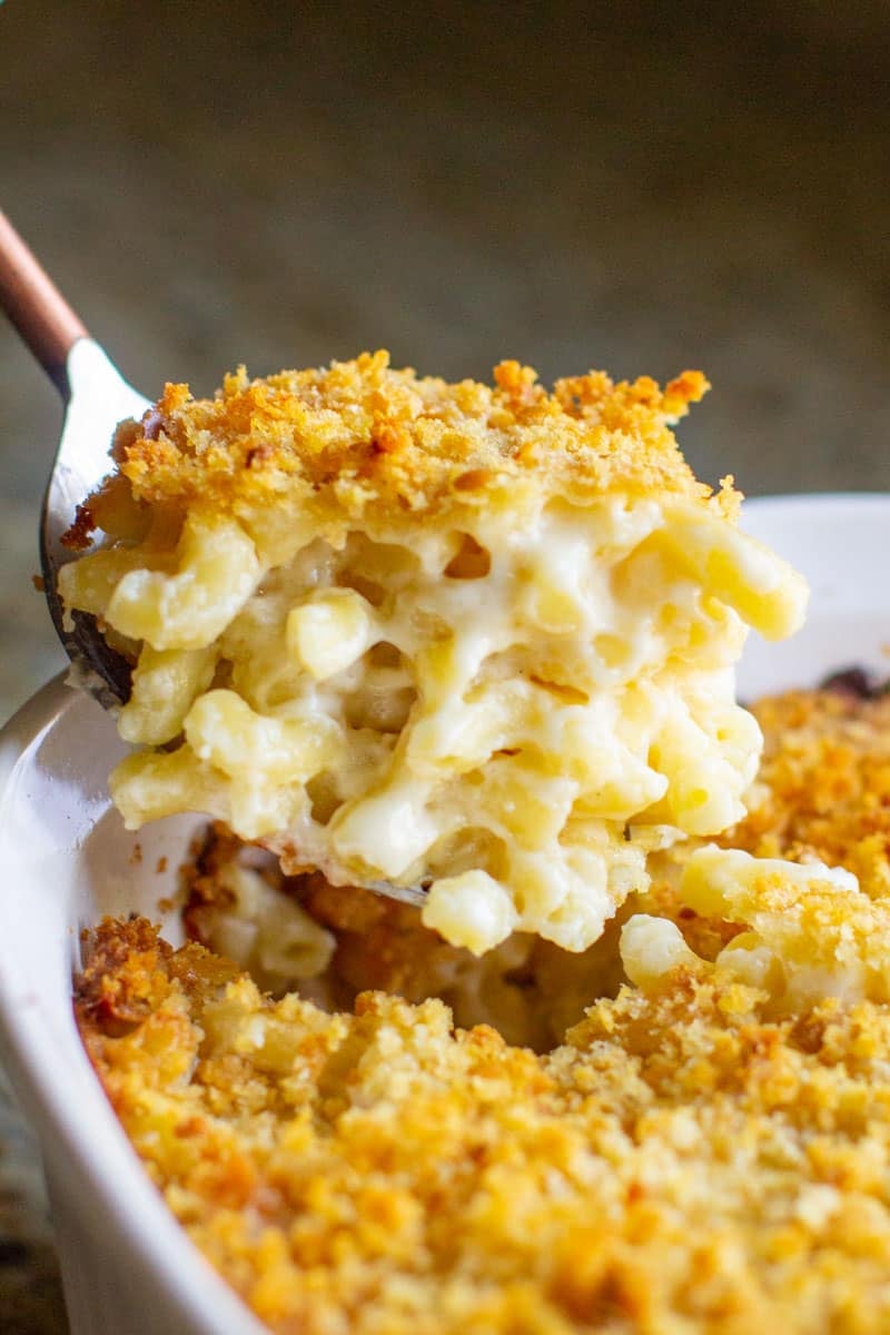A scoop of mac and cheese with garlic butter crumbs.