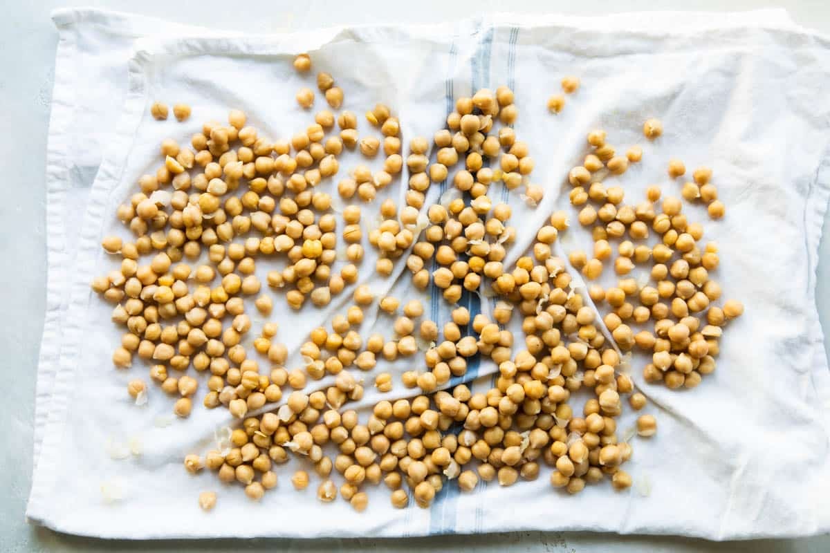 Rubbing the skins off chickpeas.