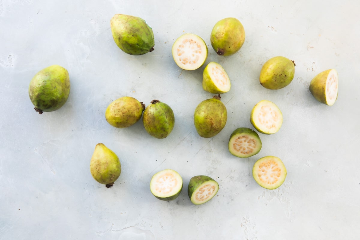 Guavas, both whole and halved.