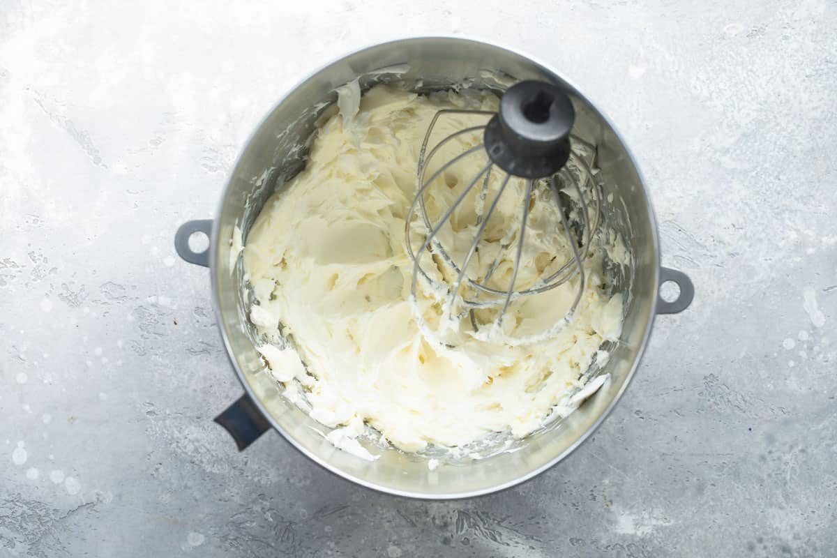 Making cream cheese frosting in a mixer.