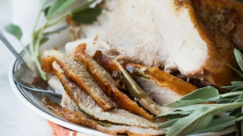 Sliced roasted turkey breast on a platter.