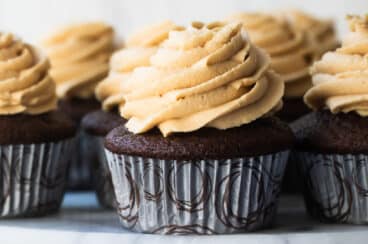 Chocolate Cupcakes with Peanut Butter Frosting on a marble platter.