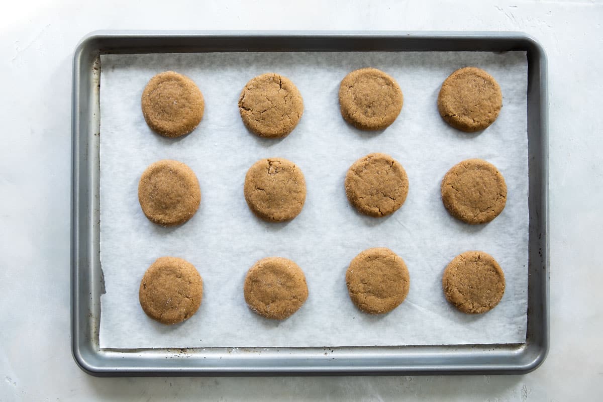 Twelve double ginger cookies on a baking sheet.