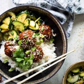 Korean barbecue meatballs, rice and cucumber in a gray bowl