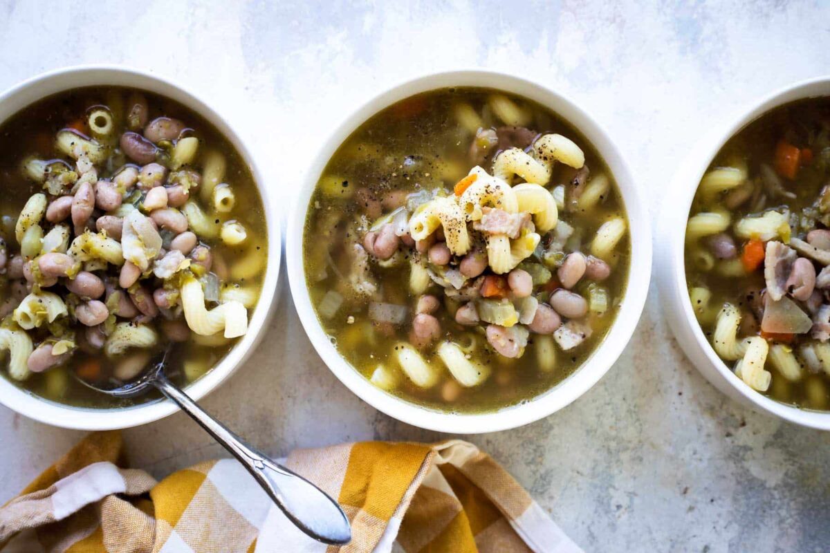 Three bowls of slow cooker pasta and bean soup.