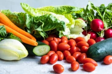 Lettuce, carrots, celery, cherry tomatoes, and beats all in a pile.