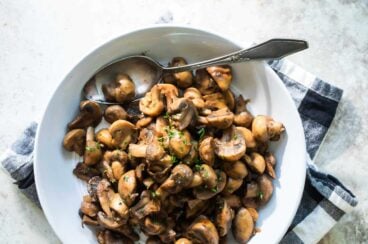 Balsamic mushrooms and onions in a white bowl.