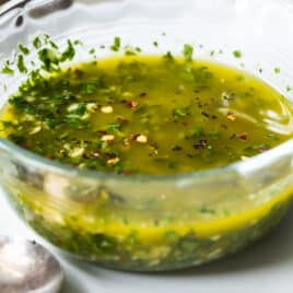 Chimichurri sauce in a small glass bowl.