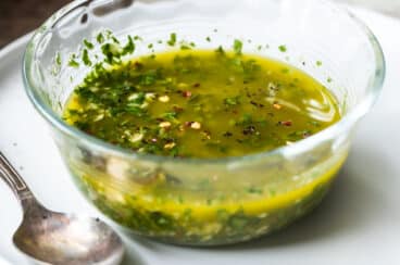 Chimichurri sauce in a small glass bowl.