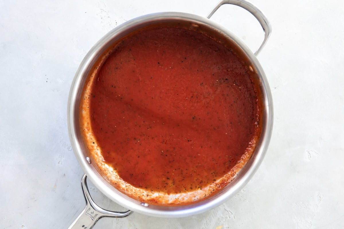A saucepan full of marinara sauce.