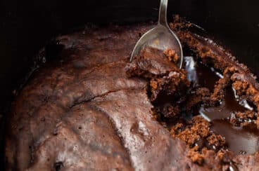 A slow cooker with chocolate lava cake in it.
