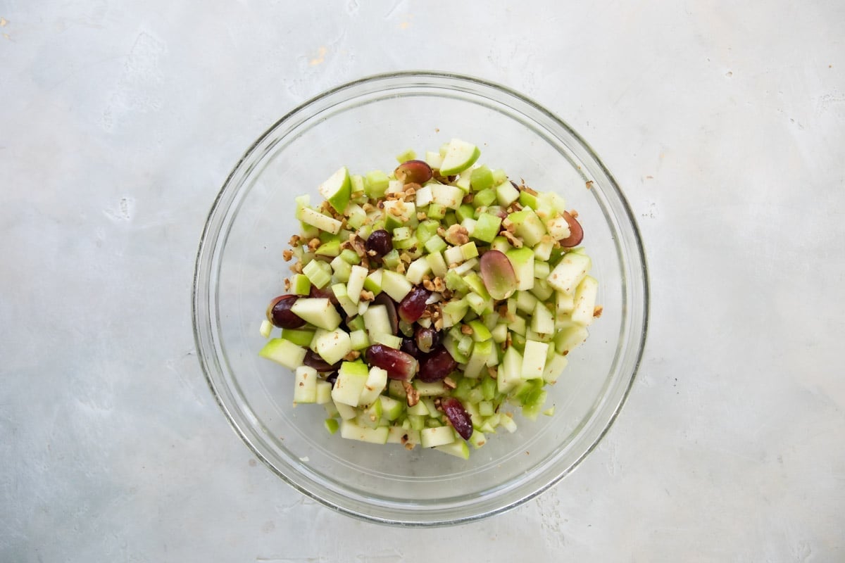 Ingredients for Waldorf salad in a bowl before adding dressing.