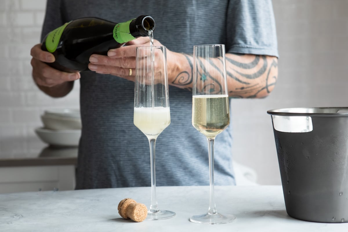 Pouring sparkling wine into a champagne flute.