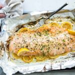 Baked salmon on a foil lined baking sheet after being baked,