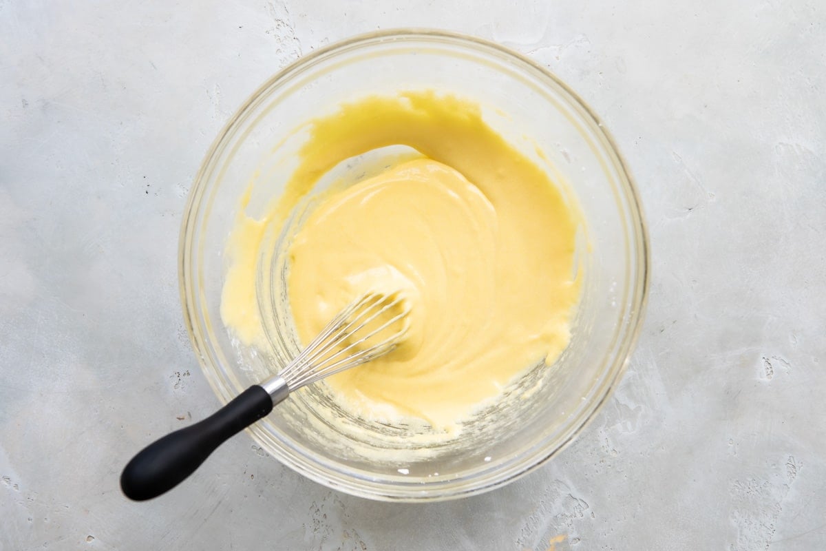 Whisking eggs and sugar together.