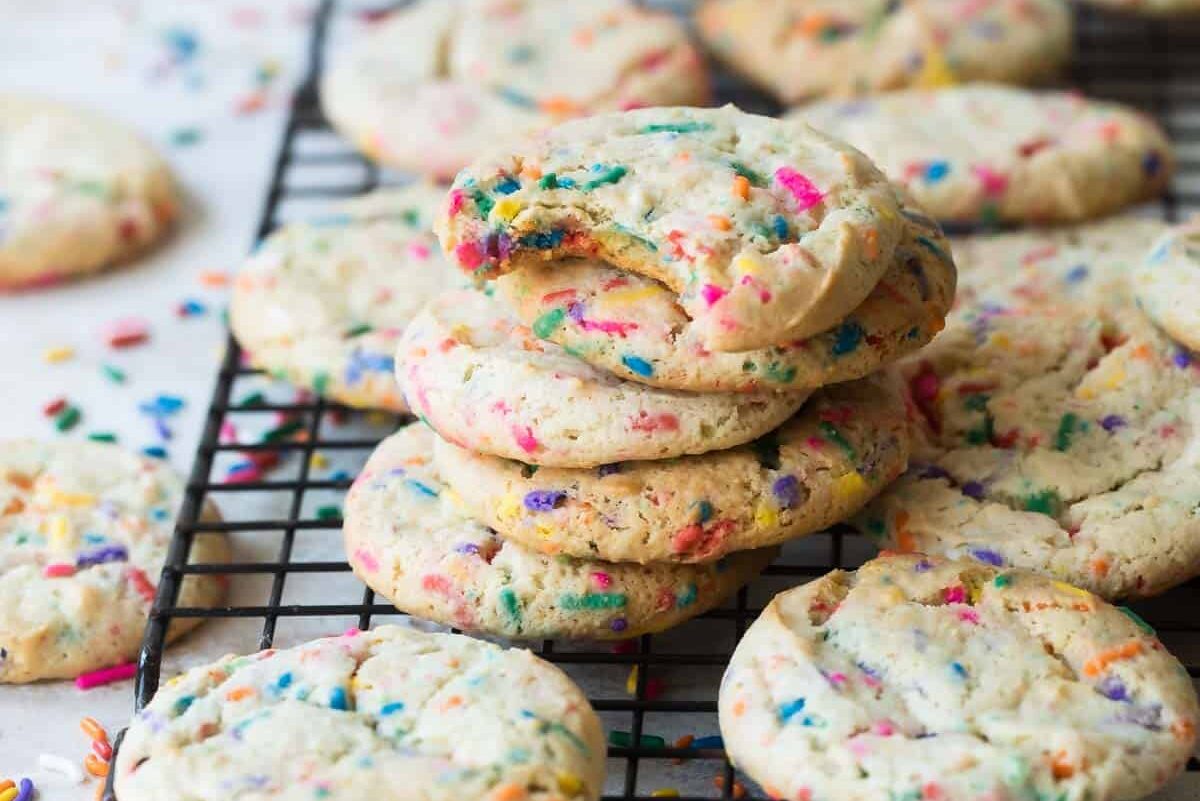 Confetti cookies on a black cooling rack.
