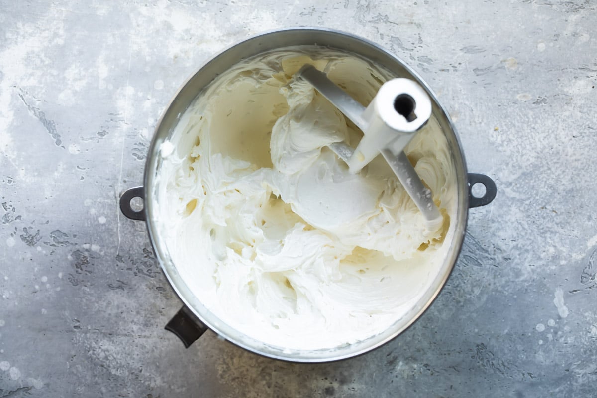 A mixing bowl full of vanilla buttercream frosting.