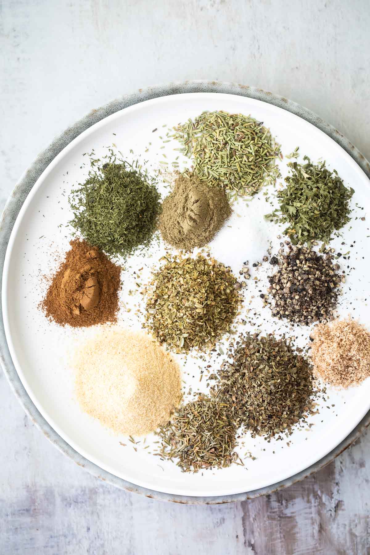 The spices for Greek seasoning on a plate.