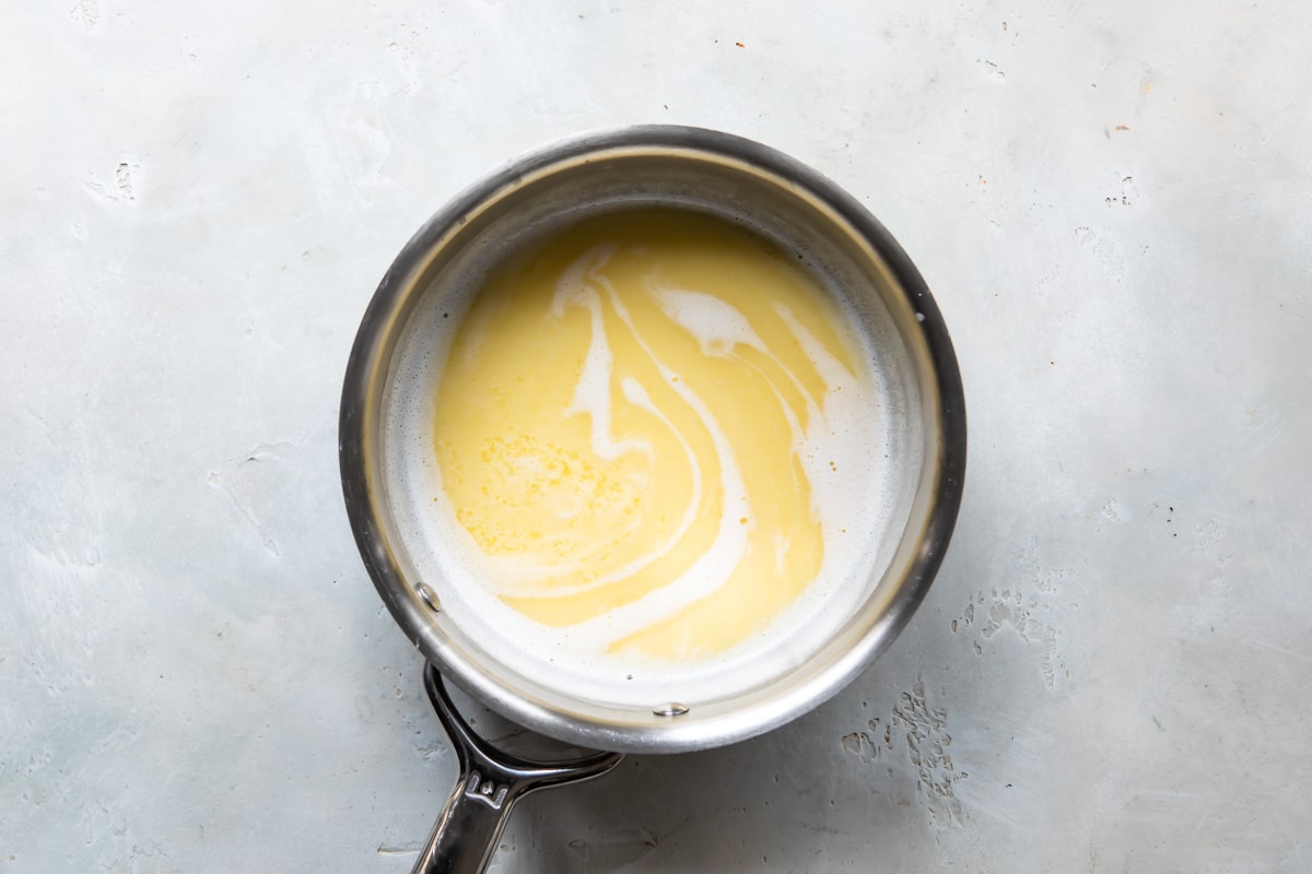 Butter, milk, and vanilla cooking in a saucepan.