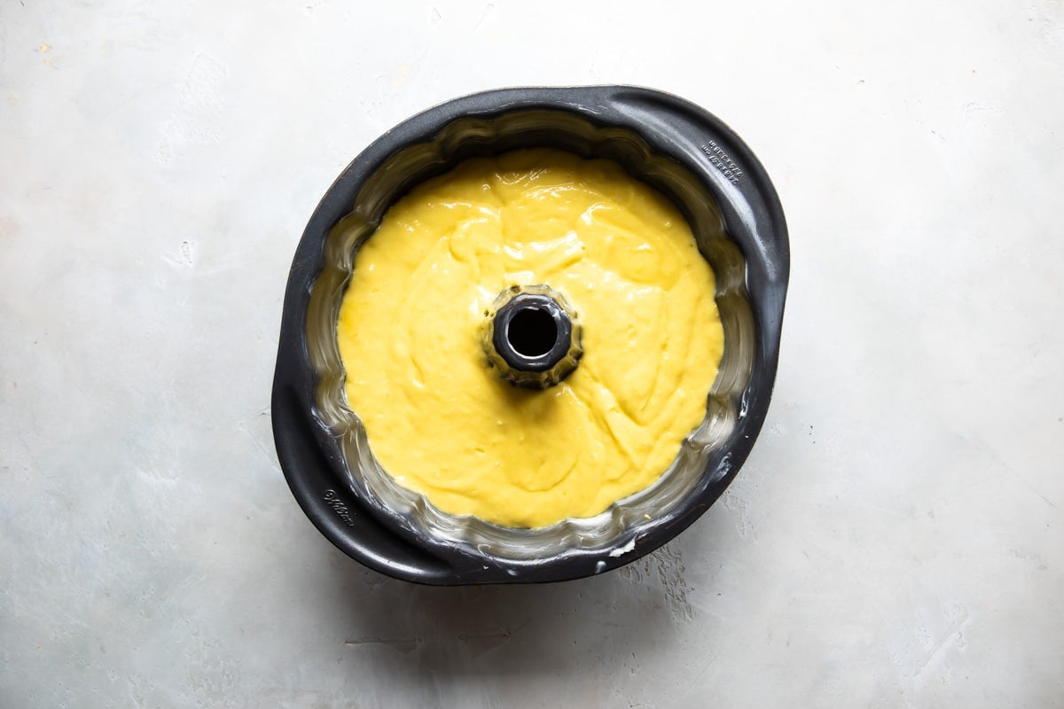Lemon bundt cake batter in a bundt pan.