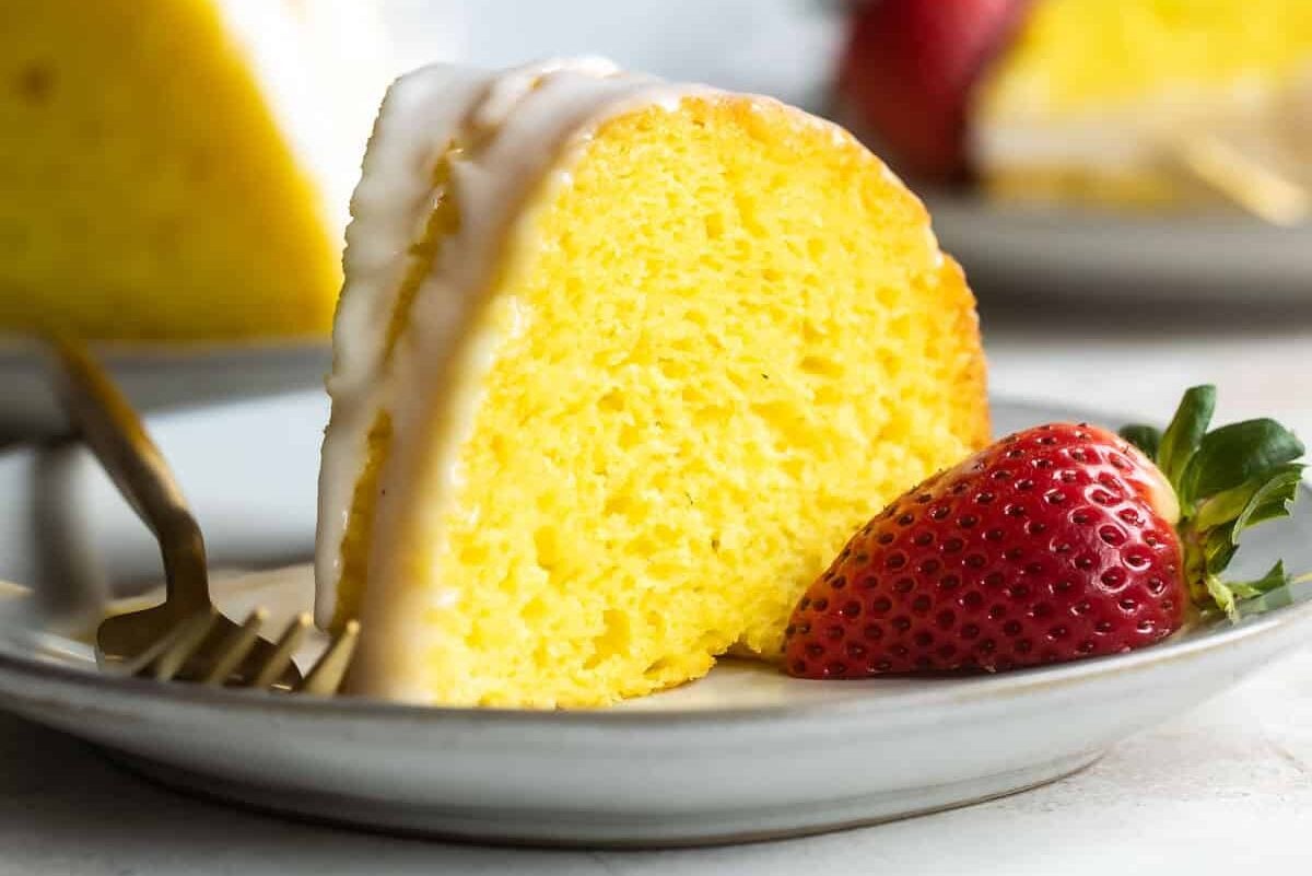 Slices of lemon bundt cake plated with strawberries.