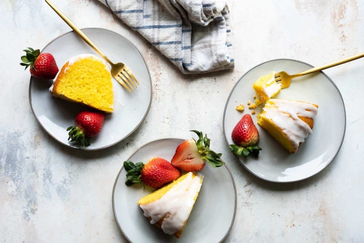 Slices of lemon bundt cake plated with strawberries.