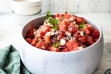 Watermelon in a white serving bowl.
