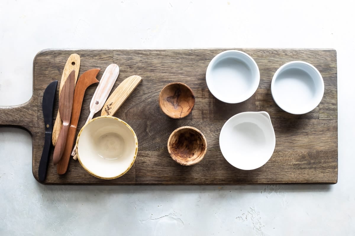 Tools and bowls for a cheese board.
