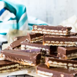 A stack of homemade Twix bars on a cooling rack.