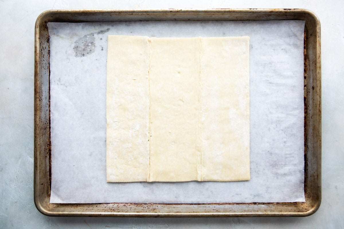 A sheet of puff pastry on a baking sheet.