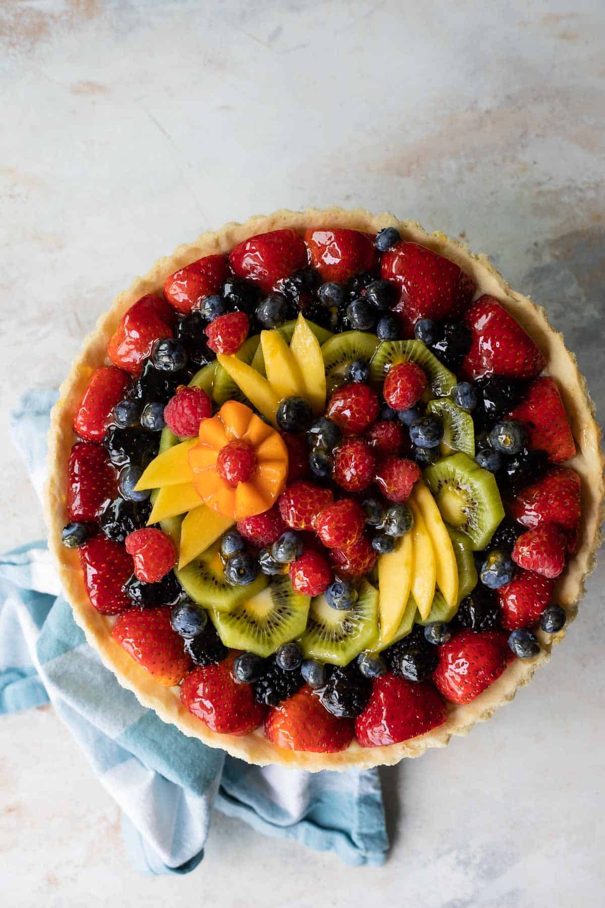 A whole, unsliced fresh fruit tart.