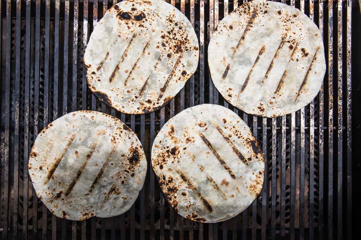 Tortillas being heated on a grill.
