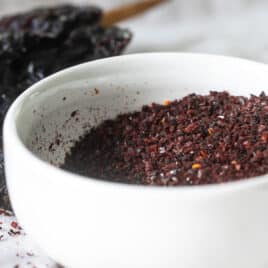Homemade Ancho Chile Powder in a white bowl.