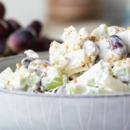A white bowl with Waldorf salad in it.