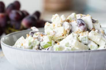 A white bowl with Waldorf salad in it.