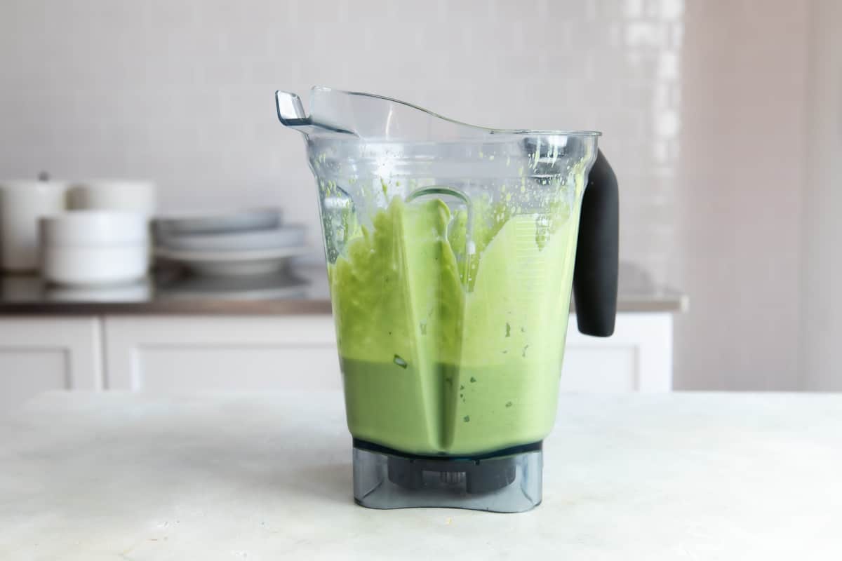 An avocado smoothie in a blender.