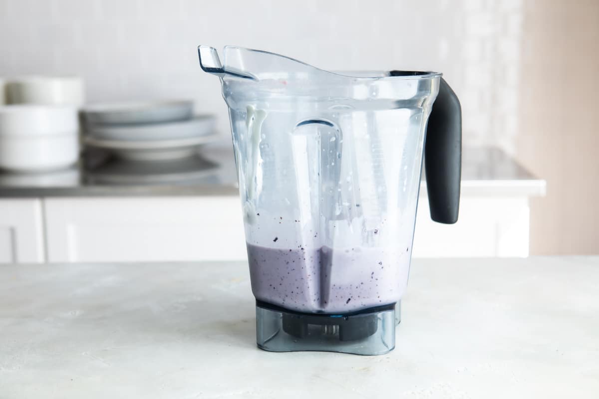 Blueberry smoothie ingredients in a blender.