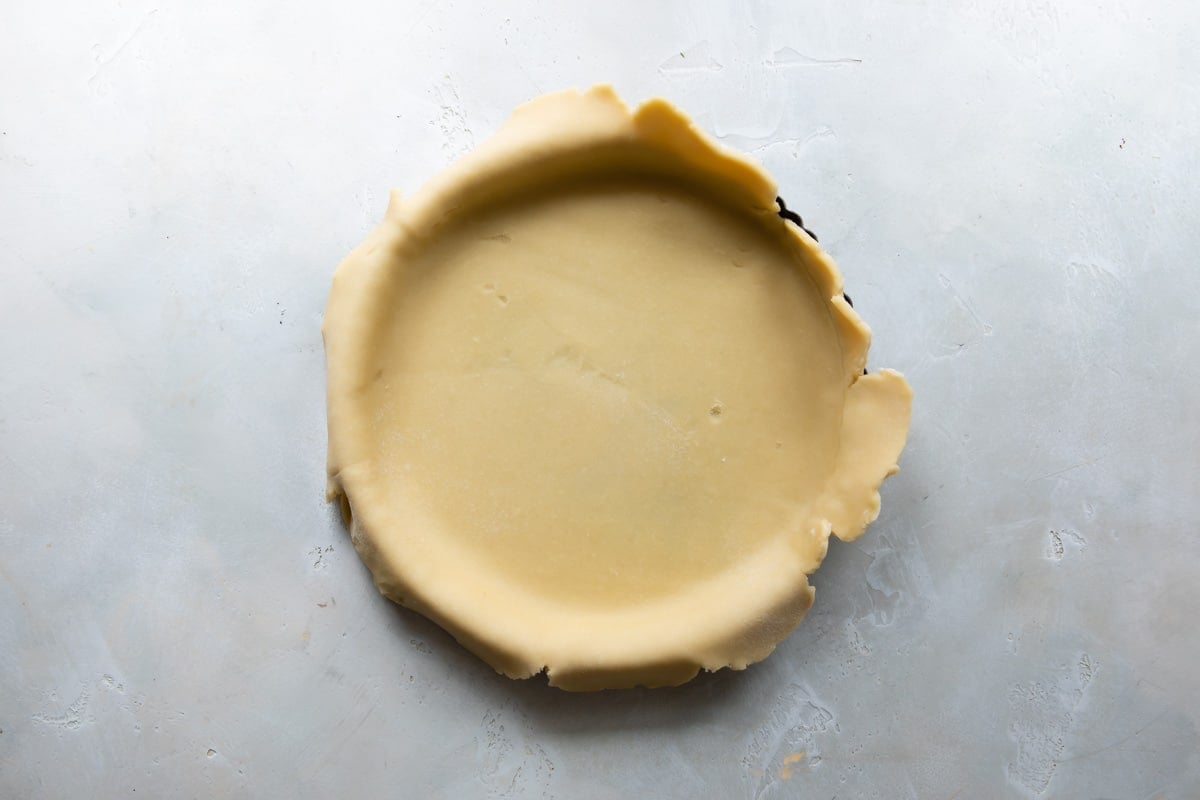 A tart crust before being trimmed and baked.