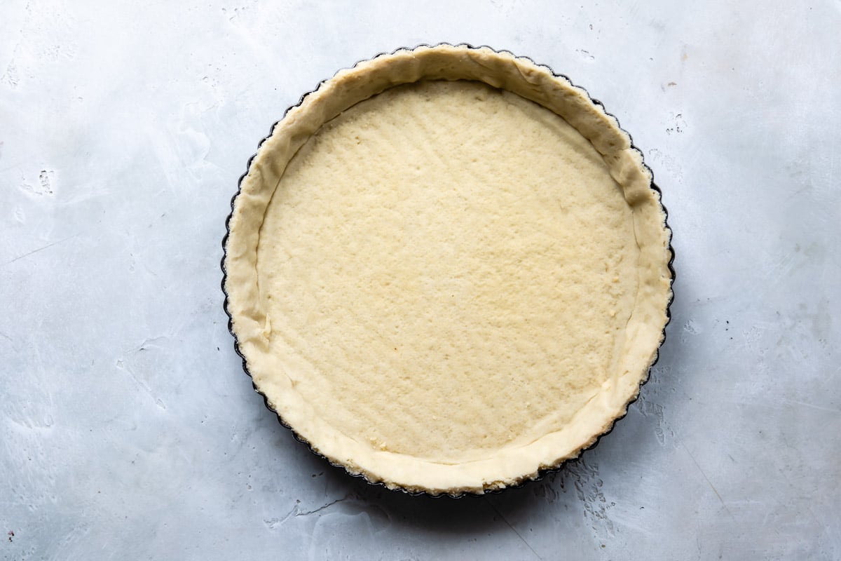 A baked tart crust on a counter top.