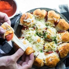Pepperoni pizza bites being pulled apart.