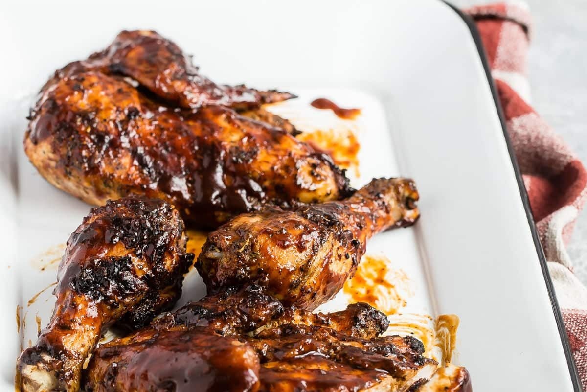 Barbecue chicken on a white platter.