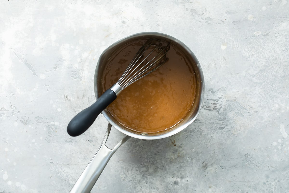 Caramel sauce in a silver sauce pan.