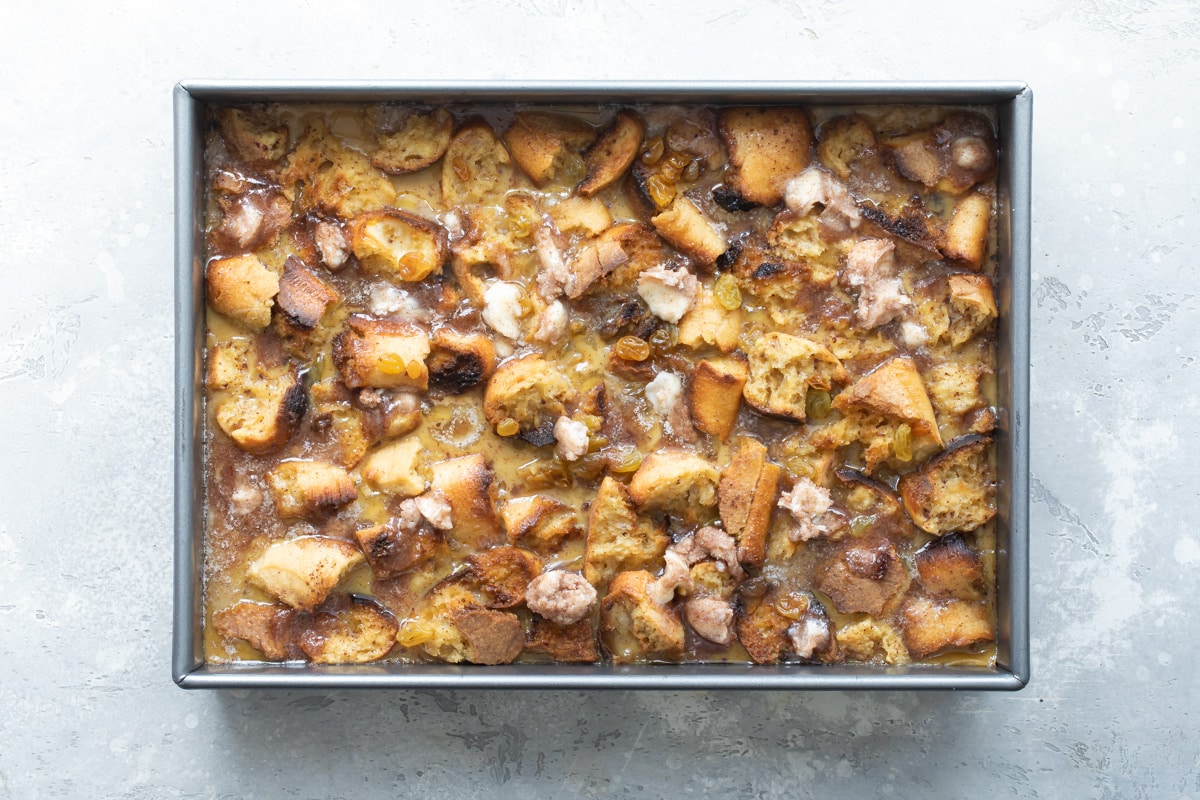 Baked bread pudding in a rectangle baking pan.